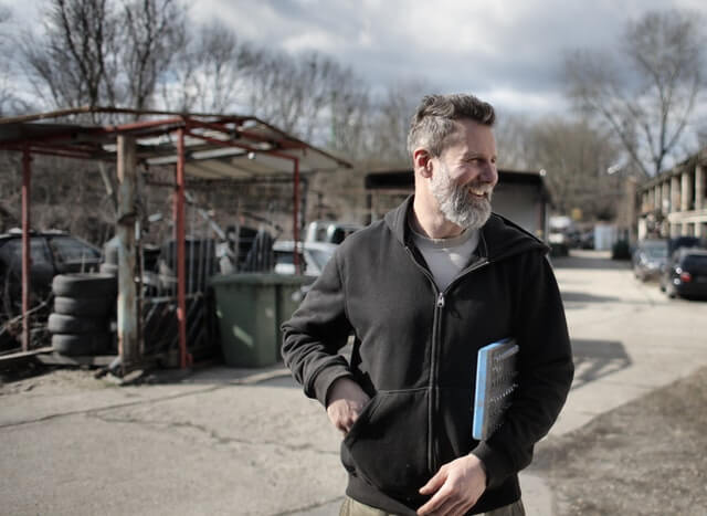 A man holding a book in his hand.