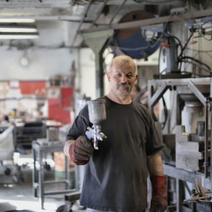 A man holding an object in his hand.